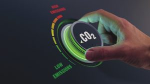 IWM-Aktuell Foto-Schalter-300x169 Lower CO2 emissions to limit global warming and climate change. Concept with manager hand turning knob to reduce levels of CO2. New technology to decarbonize industry, energy and transport  